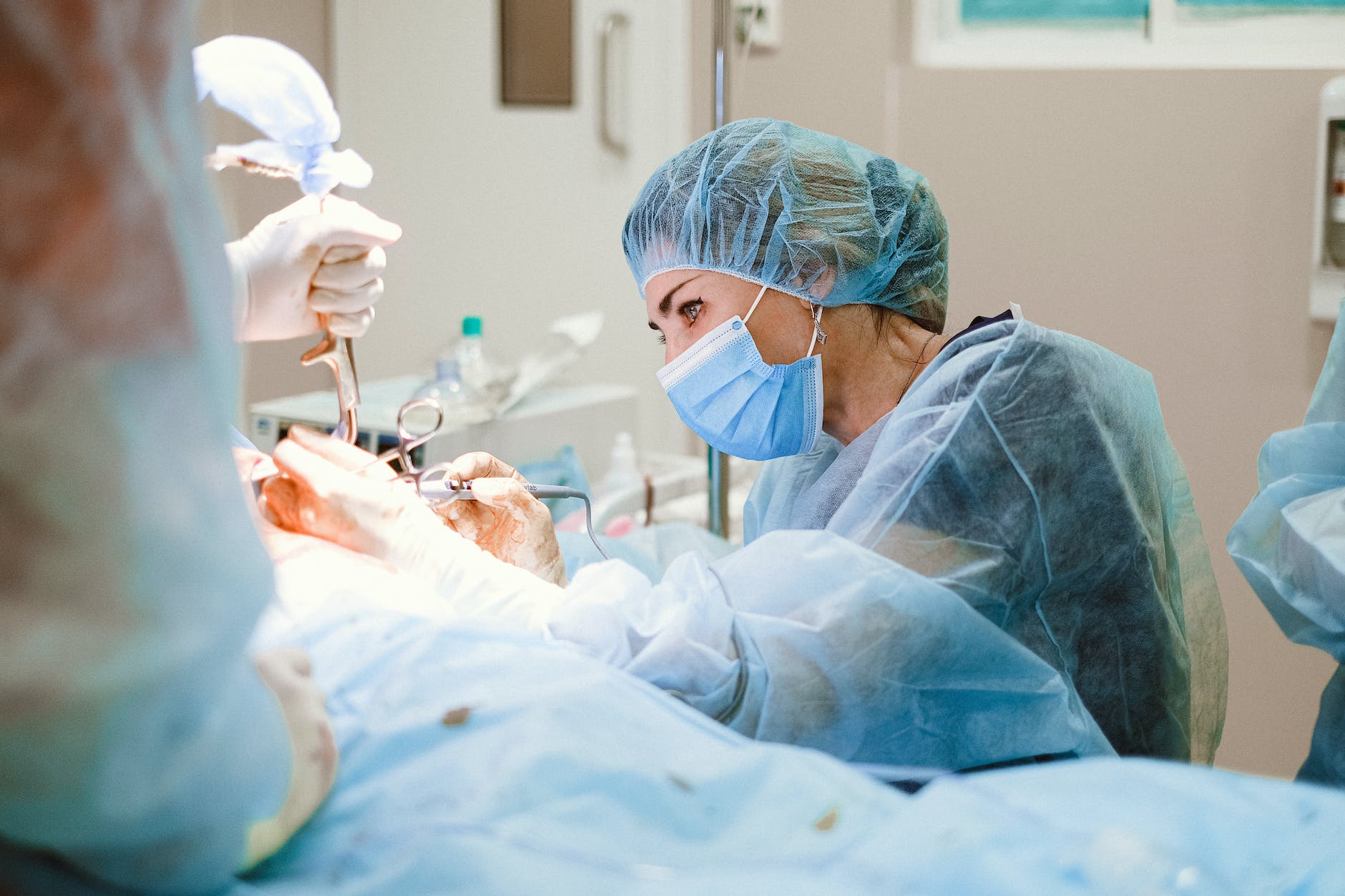 woman doing a surgery on a patient