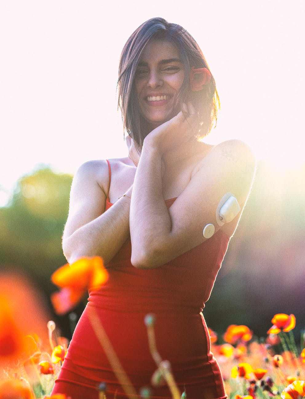 woman in orange tube dress smiling