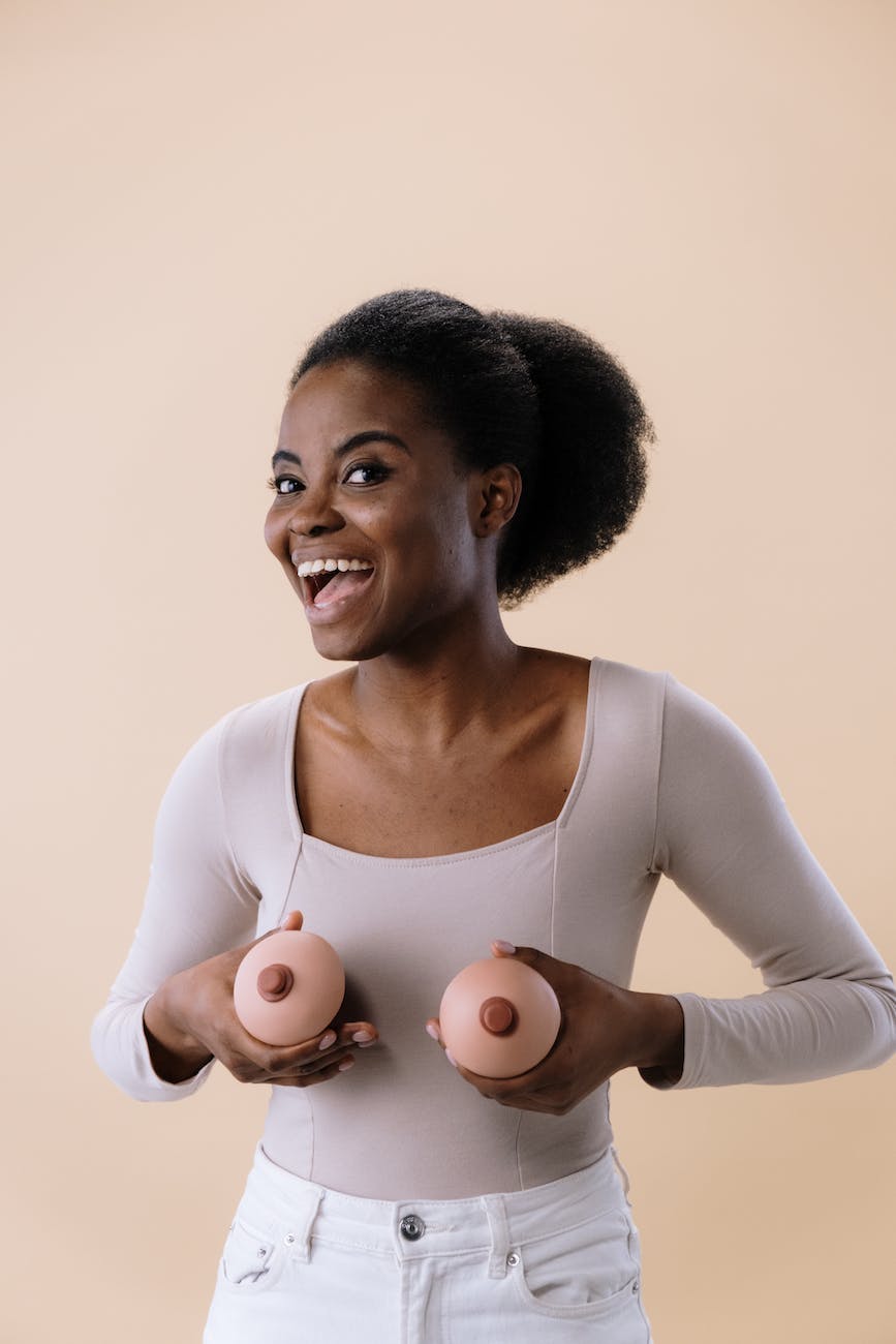 woman in white long sleeve shirt holding breast like toys