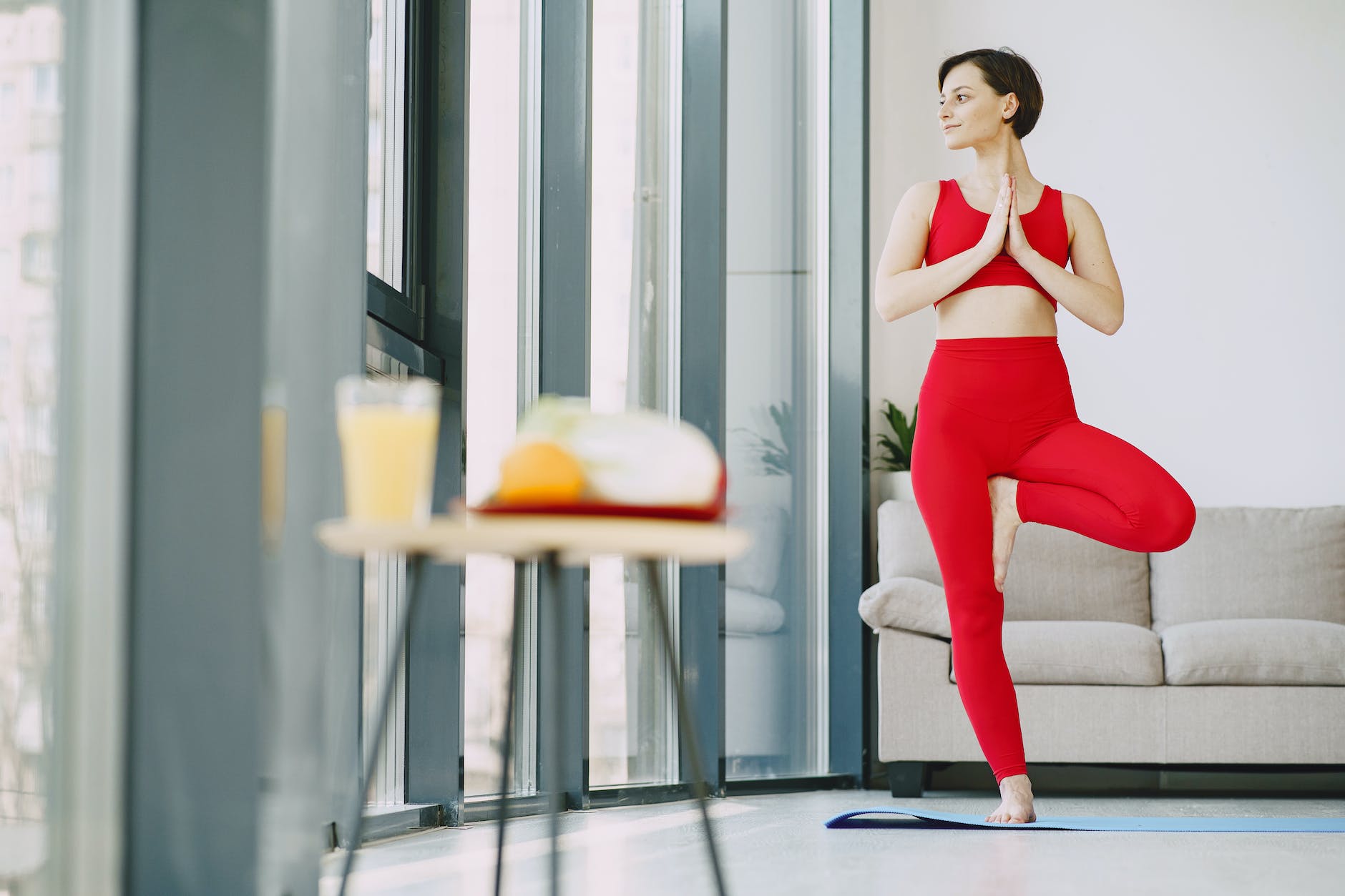 slim woman doing yoga exercise in living room