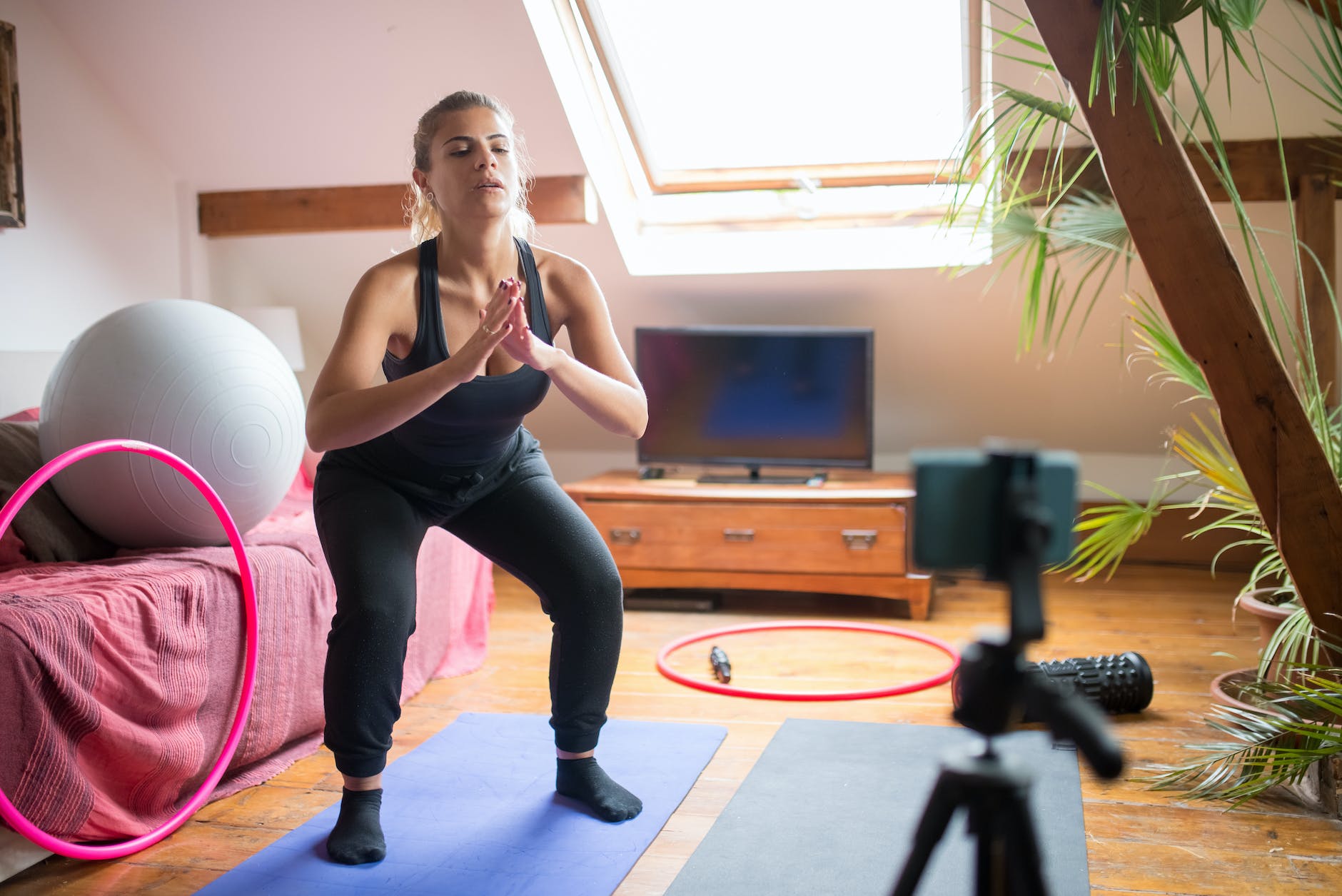 a woman doing exercise while recording herself