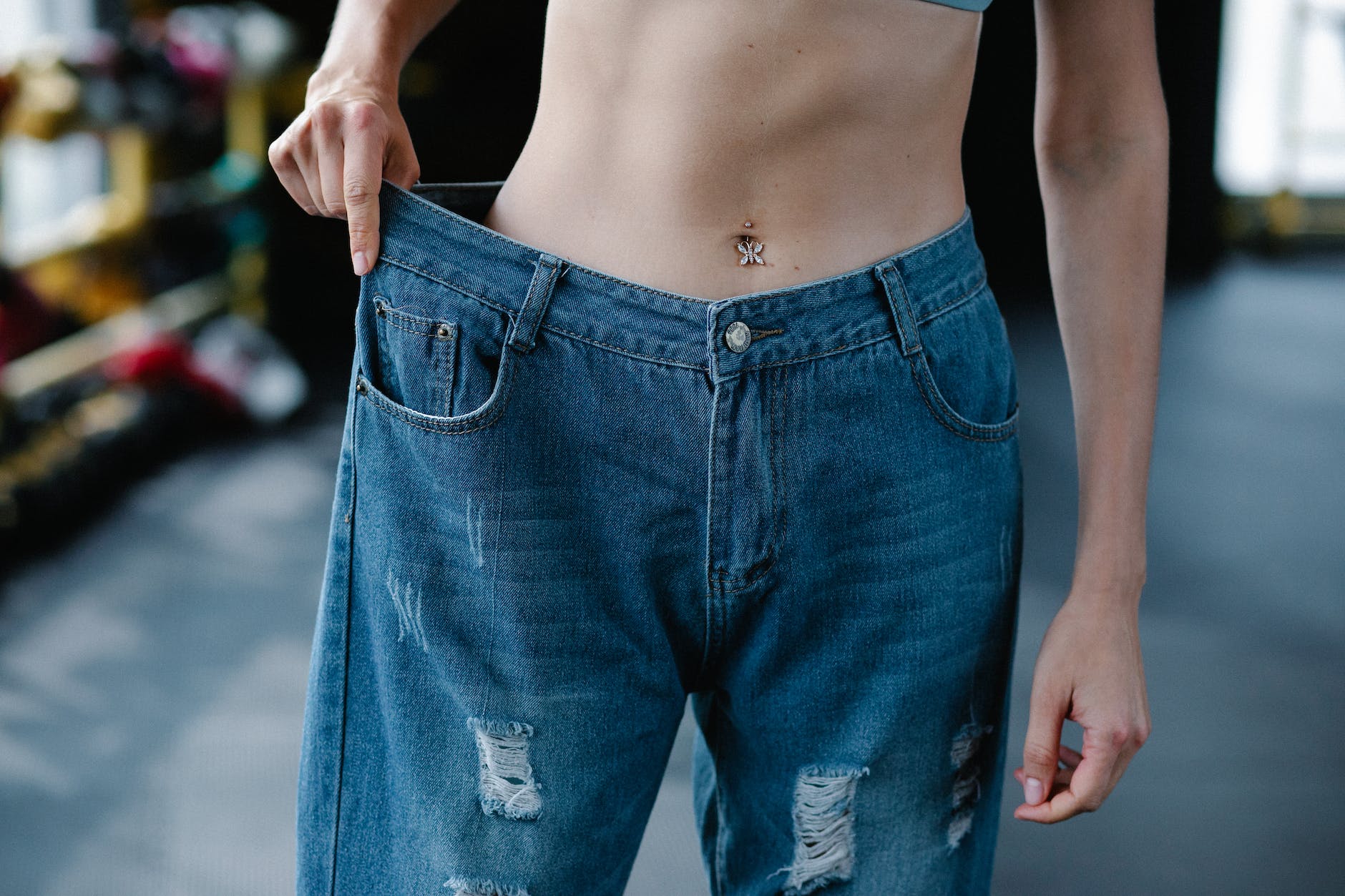 close up of woman wearing loose pants after diet