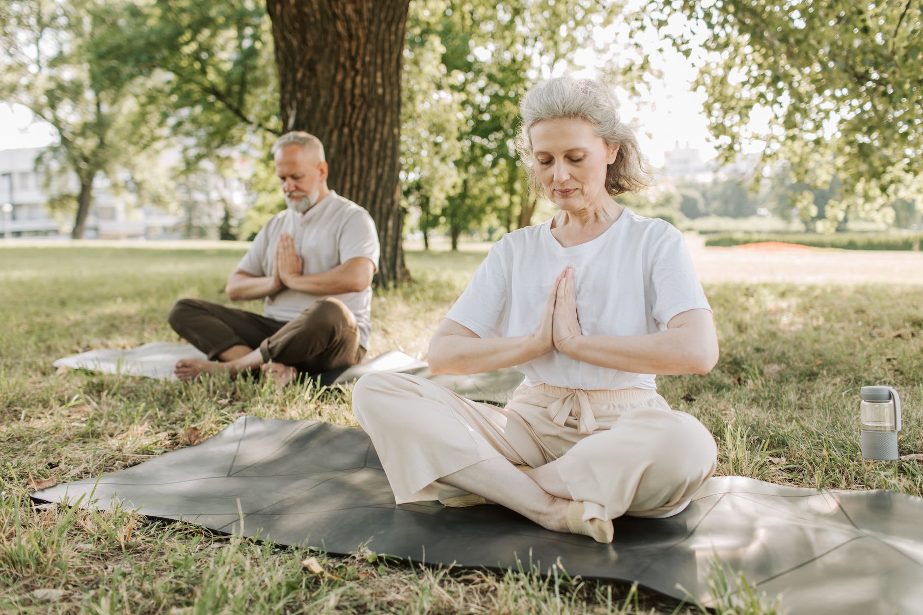 photo of an elderly couple doing yoga together
