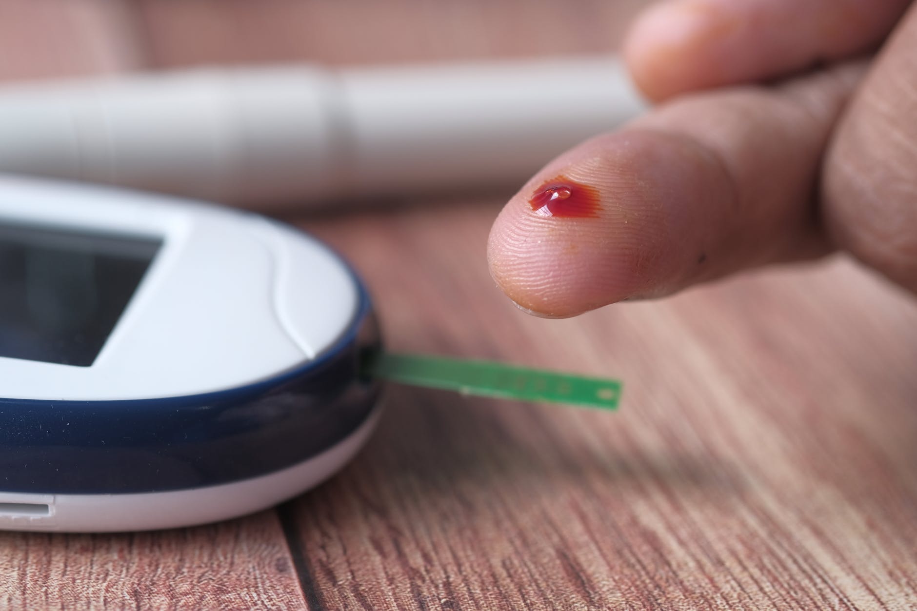 close up of person using a blood glucose monitor