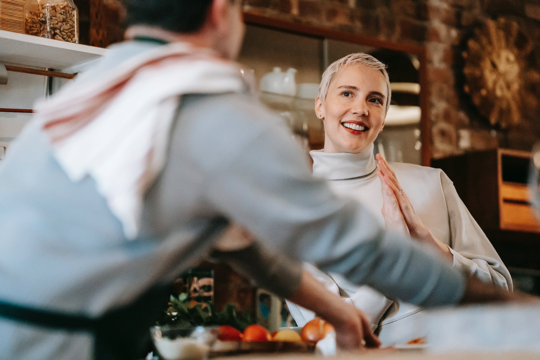 couple at kitchen while man cooking dinner on counter