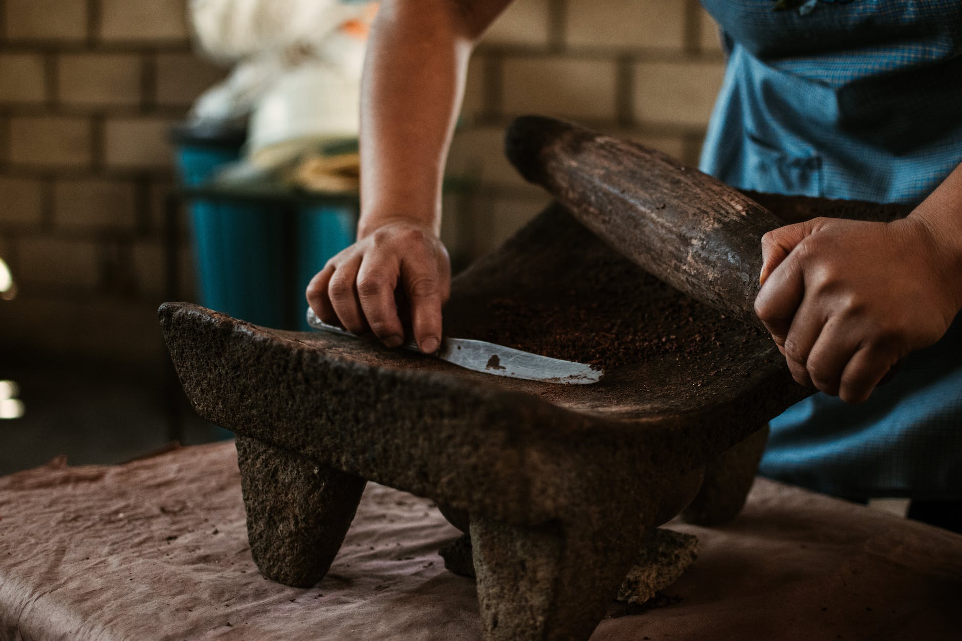close up of a person using a grinding stone