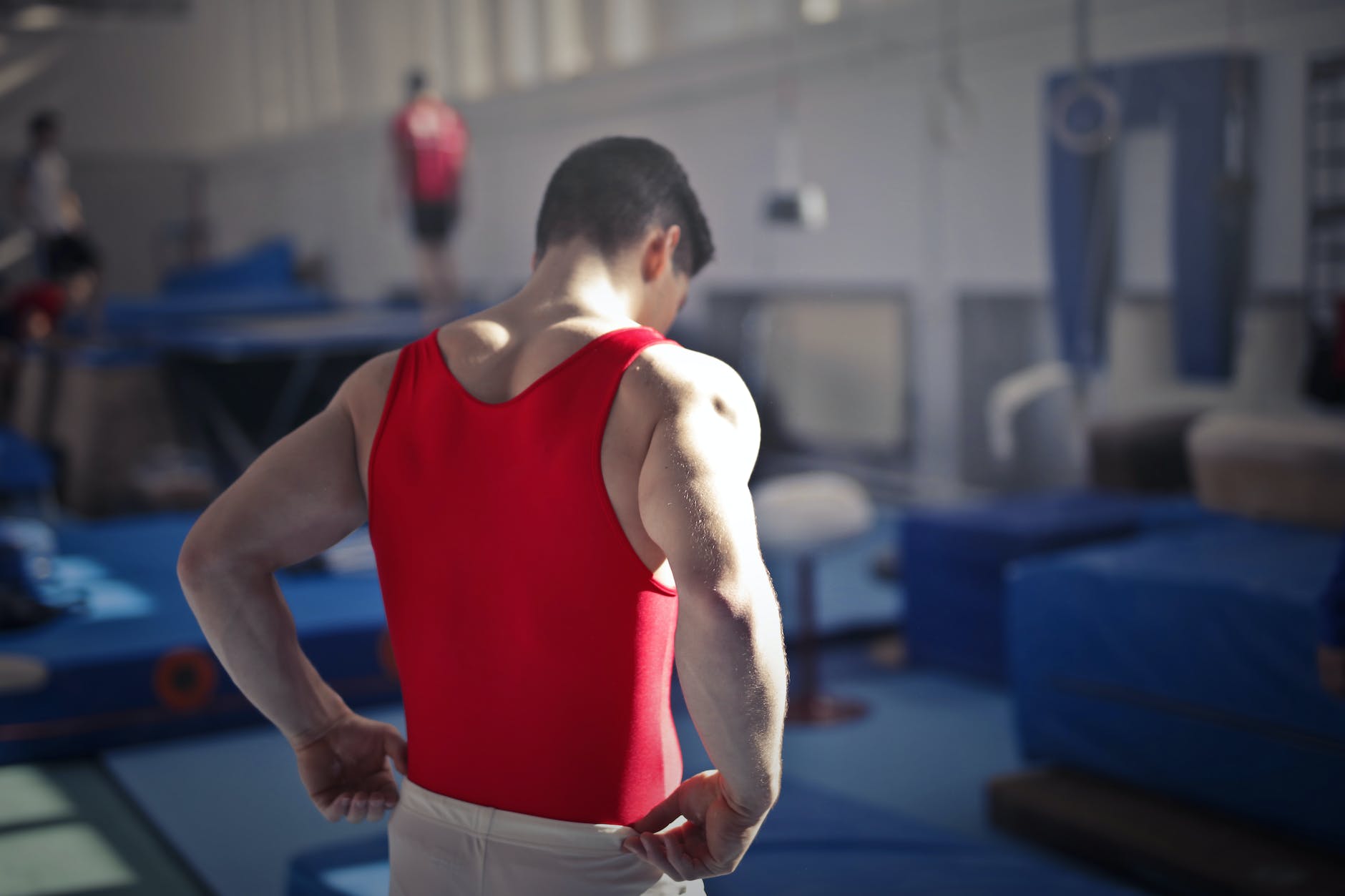male gymnast in spacious sports hall