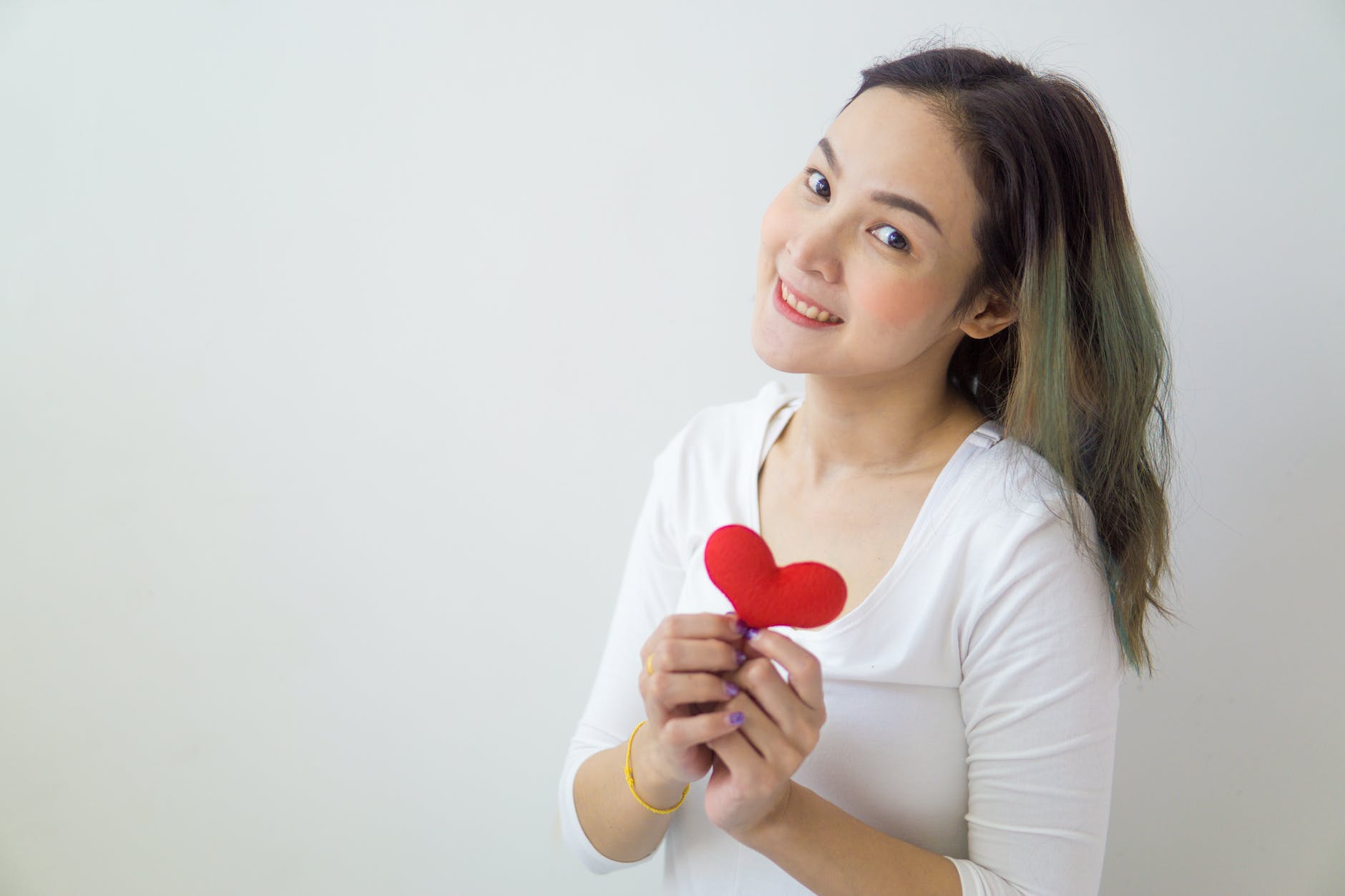 pleased woman with small heart in hands