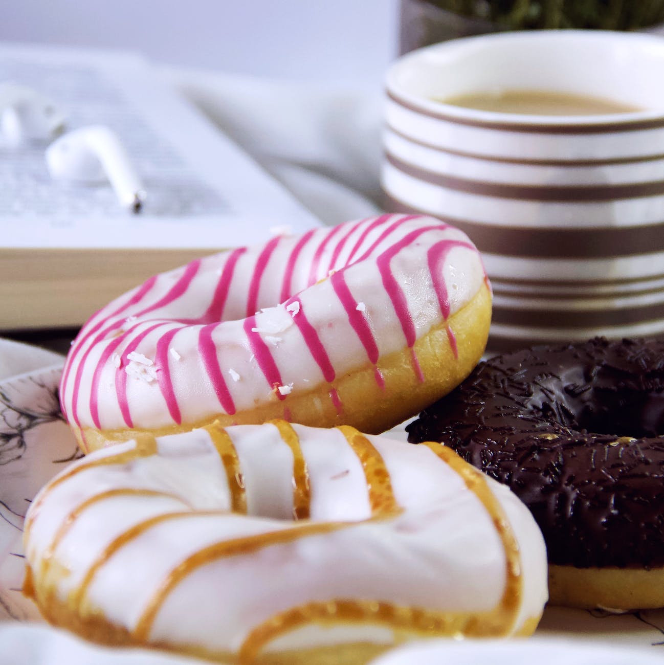 glazed doughnuts with coffee and book for hobby